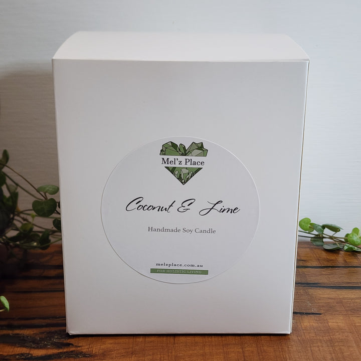 A white soy candle box is shown. The candle brand is Mel'z Place and scent is coconut and lime.