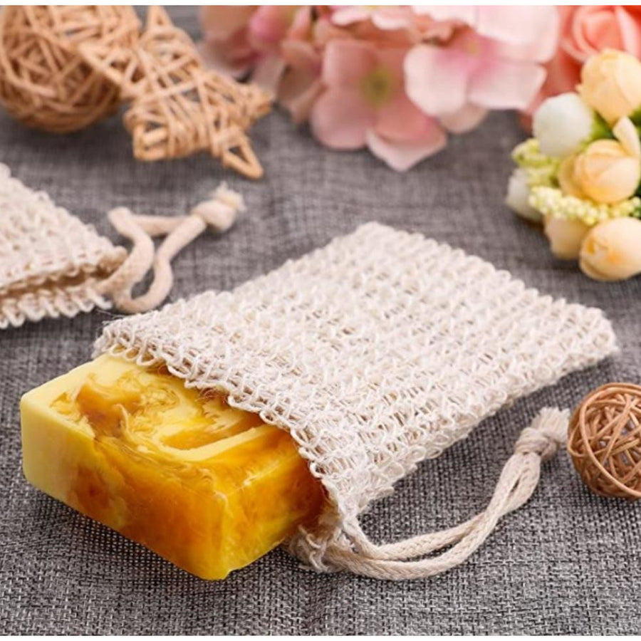 A bar of soap wrapped in a beige sisal soap mesh bag.