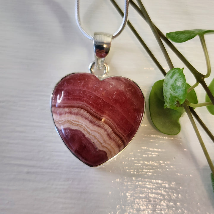 Rhodochrosite 21mm Heart Pendant.
Set in 925 Sterling Silver and comes with a 925 sterling silver chain.