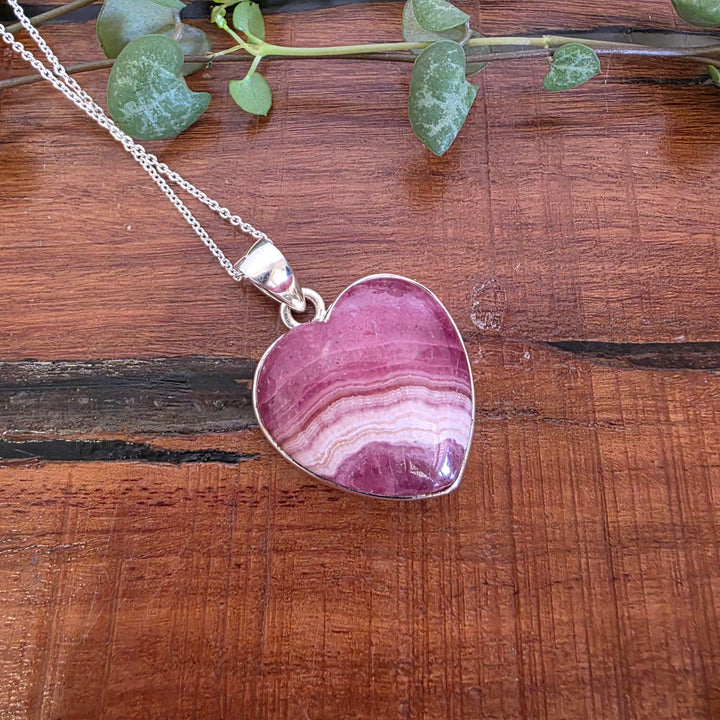 Rhodochrosite 21mm Heart Pendant.
Set in 925 Sterling Silver and comes with a 925 sterling silver chain.